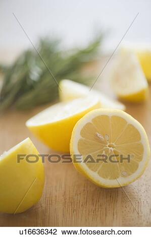 Stock Image - Lemon on chopping board. Fotosearch