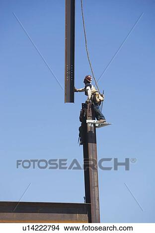 Picture - Male workers on construction site. Fotosearch