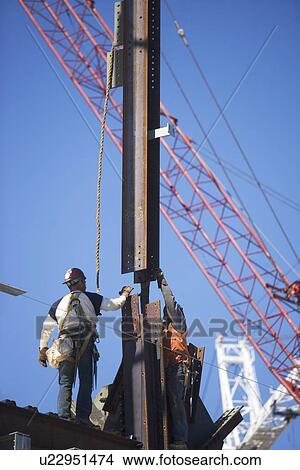Picture - Male workers on construction site. Fotosearch