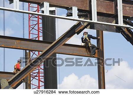 Picture - Male workers on construction site. Fotosearch