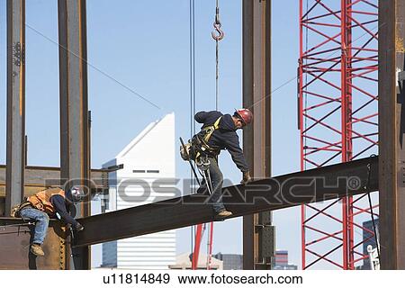 Stock Photo - Male workers on construction site. Fotosearch