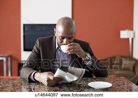 Man enjoying coffee and reading newspaper View Large Photo Image Stock Photo - Man enjoying coffee and reading newspaper. Fotosearch