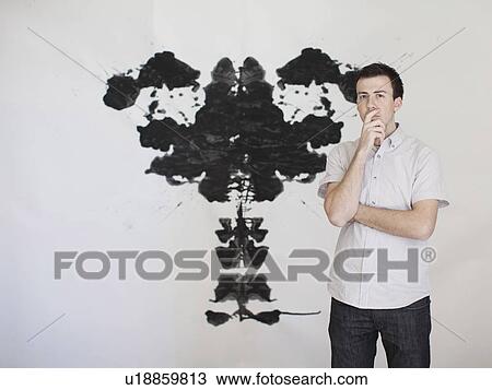 Man looking standing in front of complex shape painted on wall View Large Photo Image Stock Image - Man looking standing in front of complex shape painted on wall. Fotosearch