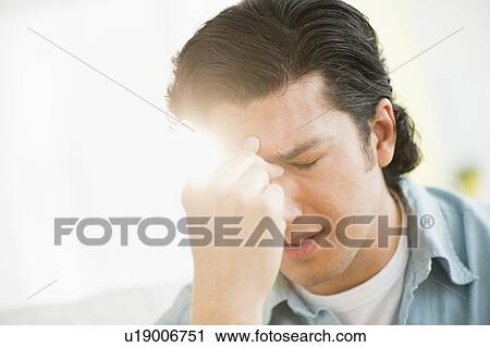 Stock Image - Man with headache. Fotosearch