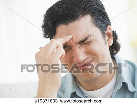 Stock Image - Man with headache. Fotosearch