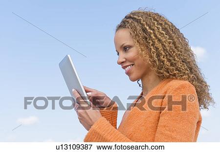 Mature woman using tablet pc View Large Photo Image Stock Photo - Mature woman using tablet pc. Fotosearch