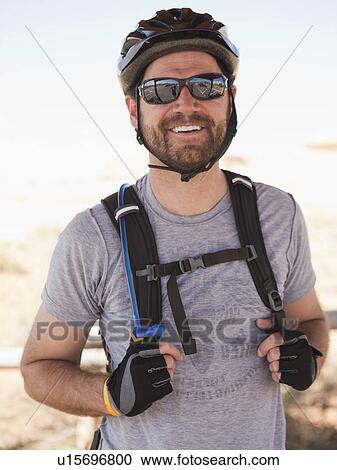 Mid adult man posing in cycling gear View Large Photo Image Stock Image - Mid adult man posing in cycling gear. Fotosearch