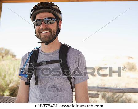 Mid adult man posing in cycling gear View Large Photo Image Stock Image - Mid adult man posing in cycling gear. Fotosearch