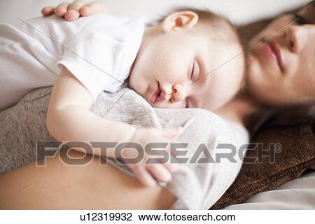 Mother and baby girl (2-5 months) sleeping together View Large Photo Image Stock Image - Mother and baby girl (2-5 months) sleeping together. Fotosearch