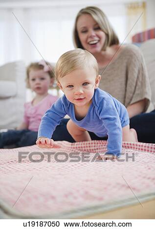 Mother and children (2-3, 6-11 months) at home View Large Photo Image Stock Image - Mother and children (2-3, 6-11 months) at home. Fotosearch