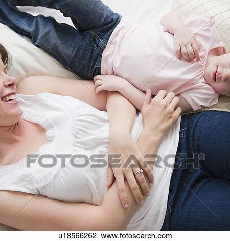 Mother and daughter (2-3) lying in bed View Large Photo Image Stock Image - Mother and daughter (2-3) lying in bed. Fotosearch