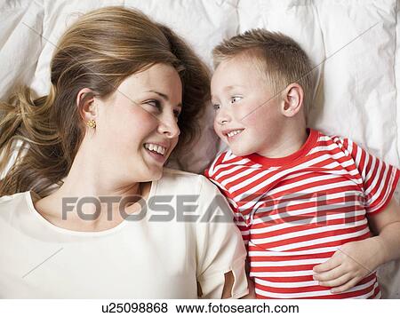 Mother and toddler boy (2-3) lying in bed View Large Photo Image Stock Photo - Mother and toddler boy (2-3) lying in bed . Fotosearch