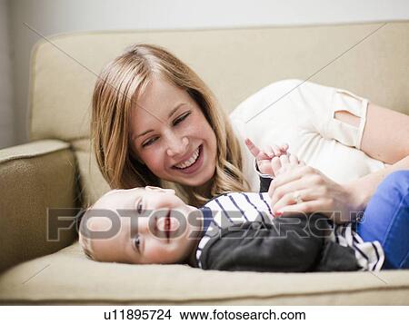 Mother embracing baby boy (12-17 months) View Large Photo Image Picture - Mother embracing baby boy (12-17 months) . Fotosearch