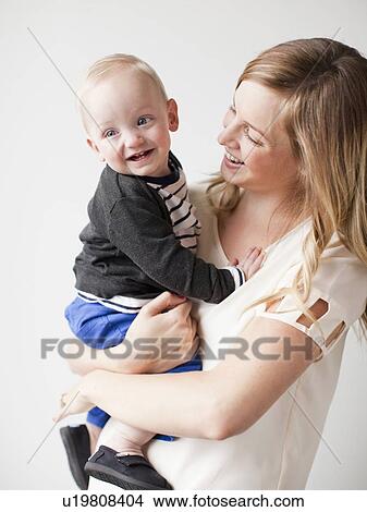 Mother embracing baby boy (12-17 months) View Large Photo Image Picture - Mother embracing baby boy (12-17 months) . Fotosearch