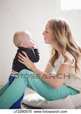Mother embracing baby boy (12-17 months) View Large Photo Image Stock Image - Mother embracing baby boy (12-17 months) . Fotosearch