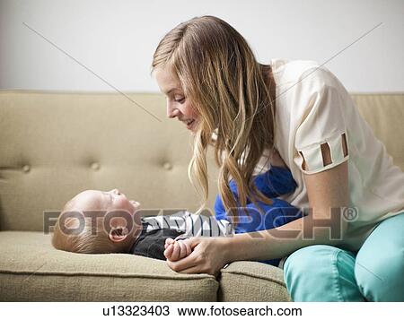 Mother embracing baby boy (12-17 months) View Large Photo Image Stock Image - Mother embracing baby boy (12-17 months) . Fotosearch