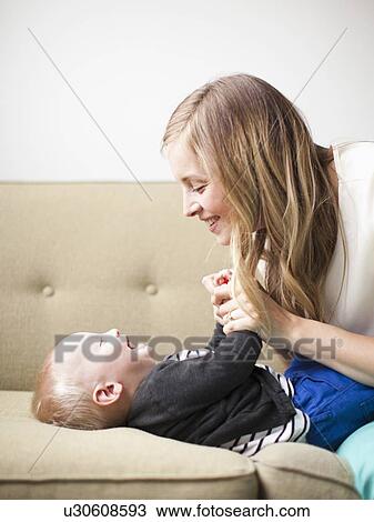 Mother embracing baby boy (12-17 months) View Large Photo Image Stock Image - Mother embracing baby boy (12-17 months) . Fotosearch