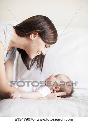 Mother embracing baby girl (2-5 months) View Large Photo Image Stock Image - Mother embracing baby girl (2-5 months). Fotosearch