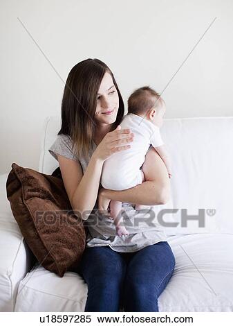 Mother embracing baby girl (2-5 months) View Large Photo Image Stock Photography - Mother embracing baby girl (2-5 months). Fotosearch