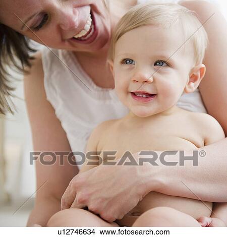 Mother holding son (6-11 months) View Large Photo Image Picture - Mother holding son (6-11 months) . Fotosearch