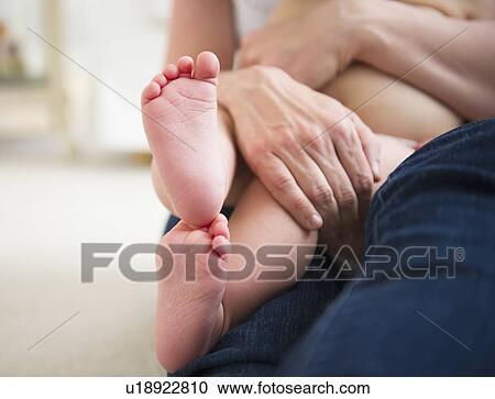 Mother holding son (6-11 months), close-up of baby feet View Large Photo Image Stock Image - Mother holding son (6-11 months), close-up of baby feet. Fotosearch
