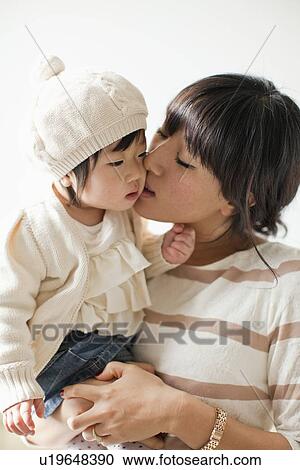 Mother kissing baby girl (12-17 months) View Large Photo Image Stock Image - Mother kissing baby girl (12-17 months). Fotosearch