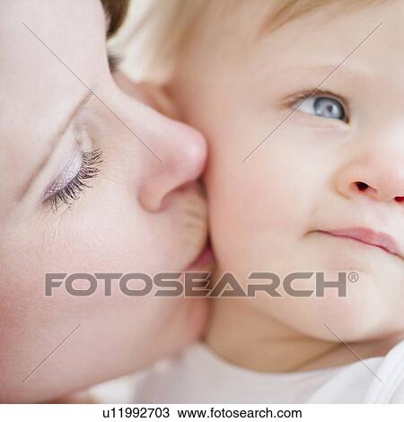 Stock Image - Mother kissing son (6-11 months). Fotosearch