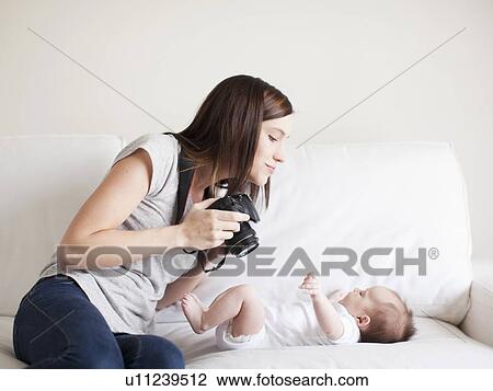 Mother photographing baby girl (2-5 months) View Large Photo Image Stock Image - Mother photographing baby girl (2-5 months). Fotosearch