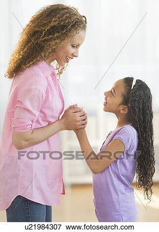 Stock Photo - Mother playing with daughter (12-13). Fotosearch