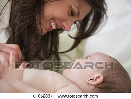 Stock Image - Mother with baby daughter (6-11 months) . Fotosearch