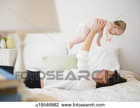 Mother with baby daughter (6-11 months) View Large Photo Image Stock Image - Mother with baby daughter (6-11 months) . Fotosearch
