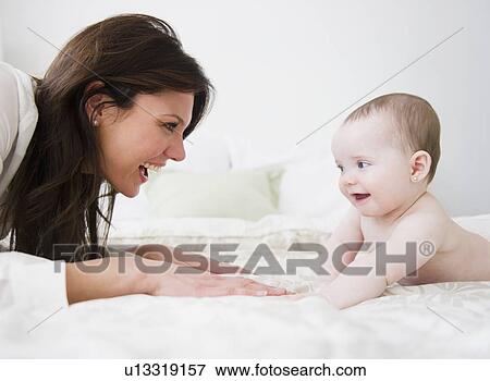 Mother with baby daughter (6-11 months) View Large Photo Image Stock Photo - Mother with baby daughter (6-11 months) . Fotosearch