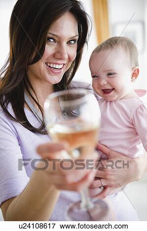 Mother with baby daughter (6-11 months) making toast View Large Photo Image Stock Photo - Mother with baby daughter (6-11 months) making toast. Fotosearch