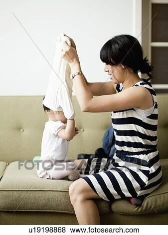 Mother with baby girl (12-17 months) View Large Photo Image Stock Photo - Mother with baby girl (12-17 months). Fotosearch