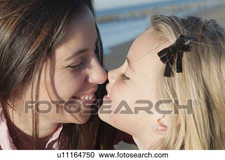 Mother with daughter exchanging eskimo kiss View Large Photo Image Stock Image - Mother with daughter exchanging eskimo kiss. Fotosearch