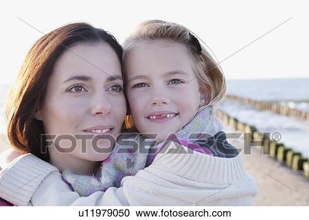 Stock Image - Mother with daughter on beach. Fotosearch