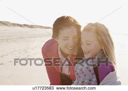 Mother with daughter on beach View Large Photo Image Stock Image - Mother with daughter on beach. Fotosearch