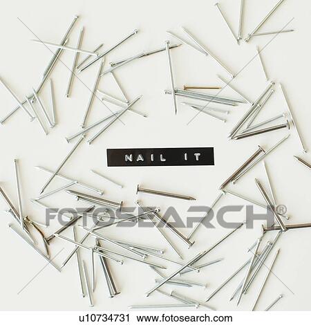 Stock Image - Nails on white background, studio shot. Fotosearch