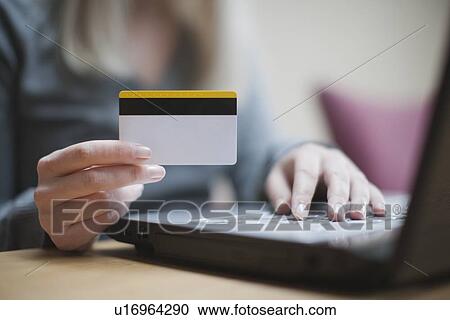 Netherlands, Goirle, Young woman shopping online View Large Photo Image Stock Image - Netherlands, Goirle, Young woman shopping online. Fotosearch