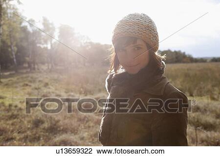 Stock Image - Netherlands, Utrechtse Heuvelrug, Portrait of young woman in winter countryside. Fotosearch