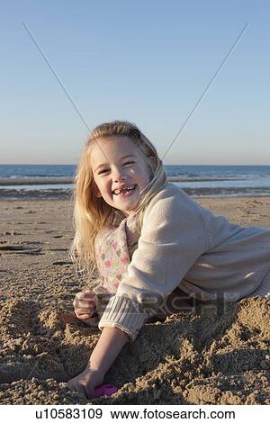 Netherlands, Zeeland, Haamstede, Girl digging sand on beach View Large Photo Image Stock Photo - Netherlands, Zeeland, Haamstede, Girl digging sand on beach. Fotosearch