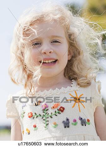 Stock Image - Outdoor portrait of happy young girl (4-5) . Fotosearch