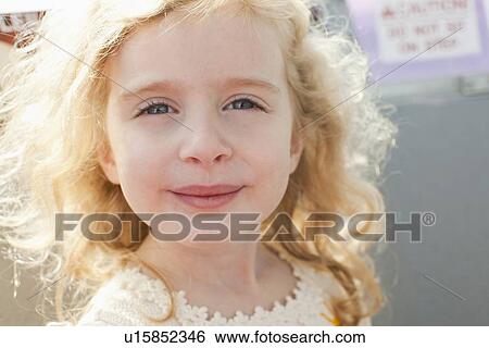 Stock Photograph - Outdoor portrait of happy young girl (4-5) . Fotosearch