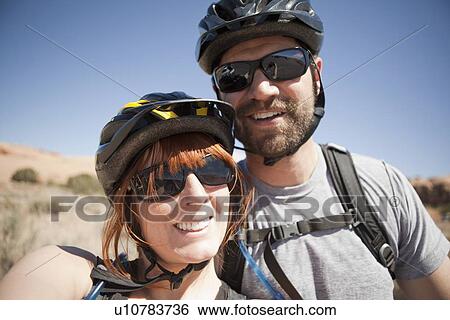 Outdoors portrait of couple in cycling gear View Large Photo Image Stock Photograph - Outdoors portrait of couple in cycling gear. Fotosearch