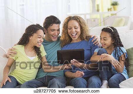 Parents with daughters (10-13) using tablet pc View Large Photo Image Stock Photography - Parents with daughters (10-13) using tablet pc. Fotosearch