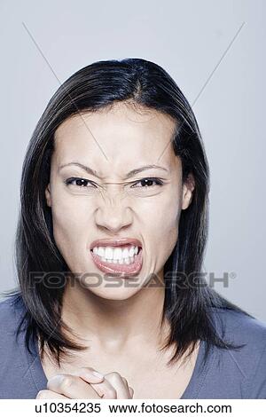 Portrait of angry young woman, studio shot View Large Photo Image Stock Photography - Portrait of angry young woman, studio shot. Fotosearch