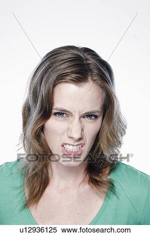 Portrait of angry young woman, studio shot View Large Photo Image Stock Photography - Portrait of angry young woman, studio shot. Fotosearch