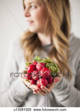 Portrait of attractive young woman holding radish View Large Photo Image Stock Photography - Portrait of attractive young woman holding radish. Fotosearch