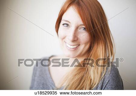 Stock Photography - Portrait of attractive young woman with dyed redhead. Fotosearch