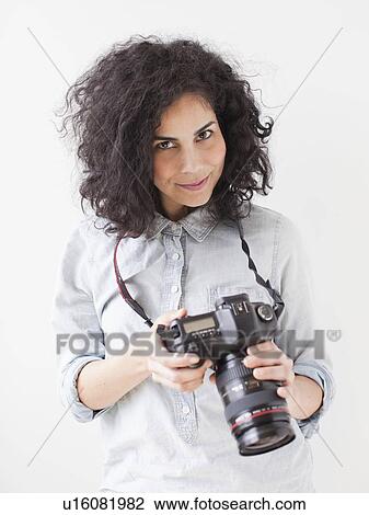 Portrait of beautiful young woman holding professional camera View Large Photo Image Stock Image - Portrait of beautiful young woman holding professional camera. Fotosearch